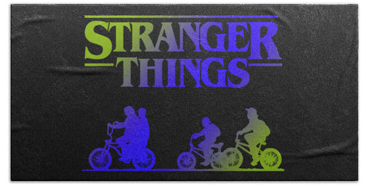 Dark beach towel with multicolor Stranger Things logo and character silhouettes