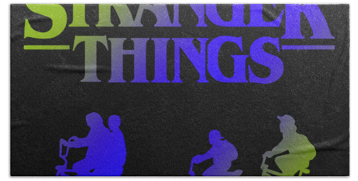 Kids bath towel with 'Stranger Things' lettering and colorful character silhouettes