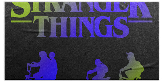 Kids bath towel with 'Stranger Things' lettering and colorful character silhouettes
