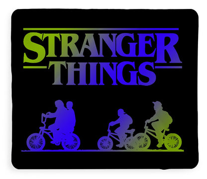 Kids blanket showing neon Stranger Things logo and bike rider silhouettes on black
