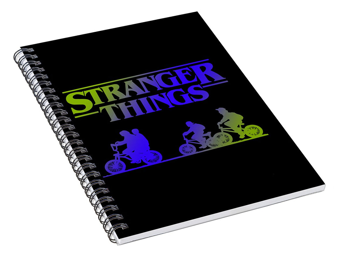 Black spiral notebook angled view with Stranger Things title and colored bike silhouettes