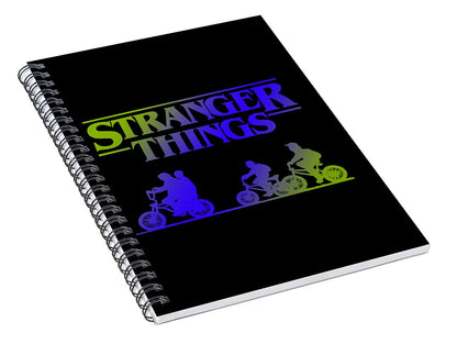 Black spiral notebook angled view with Stranger Things title and colored bike silhouettes