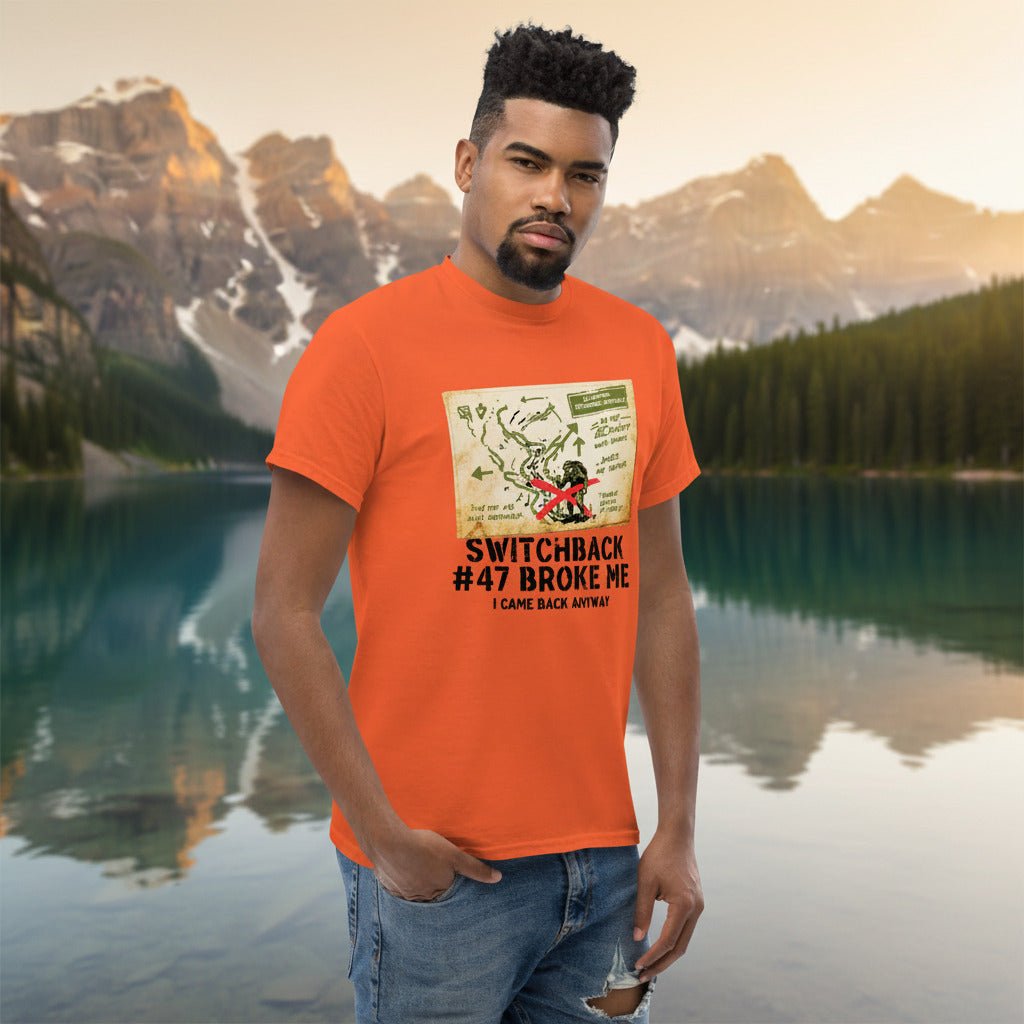 Orange hiking t-shirt with printed map graphic and red figure on the front, worn
