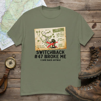 Military green hiking T-shirt with front map-style graphic and “Switchback #47 Broke Me”