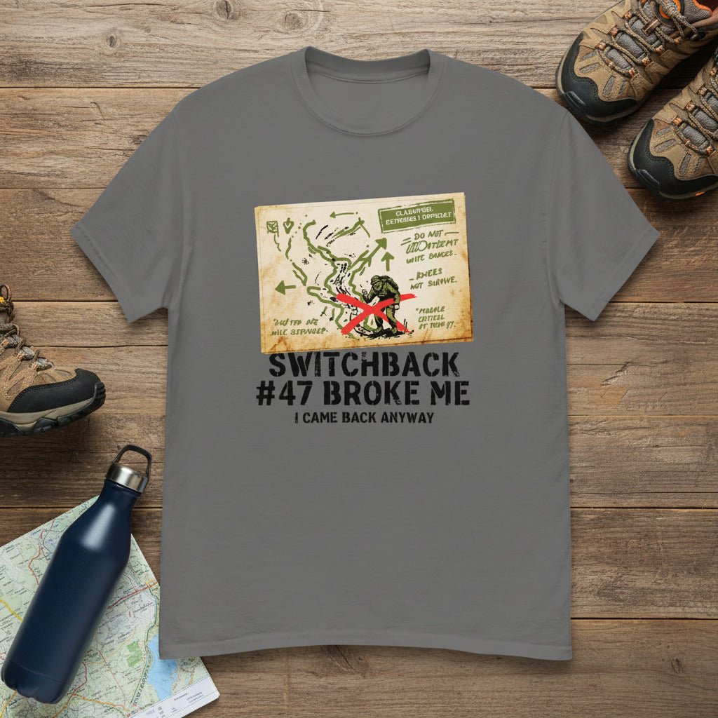 Charcoal gray hiking T-shirt with front map-style graphic and “Switchback #47 Broke Me”