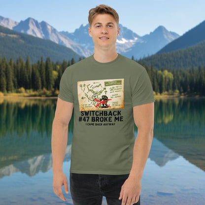 Olive green hiking t-shirt with printed map graphic and red figure on the front, worn