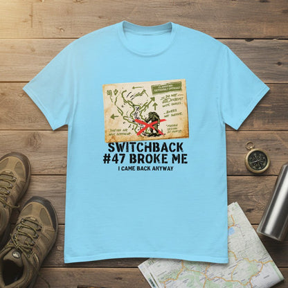 Light blue hiking t-shirt with printed map graphic and red figure on the front