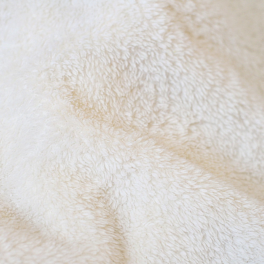 Cream fleece blanket close-up with dense, soft looped texture
