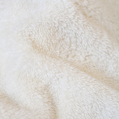 White sherpa fleece blanket fabric close-up with dense textured pile