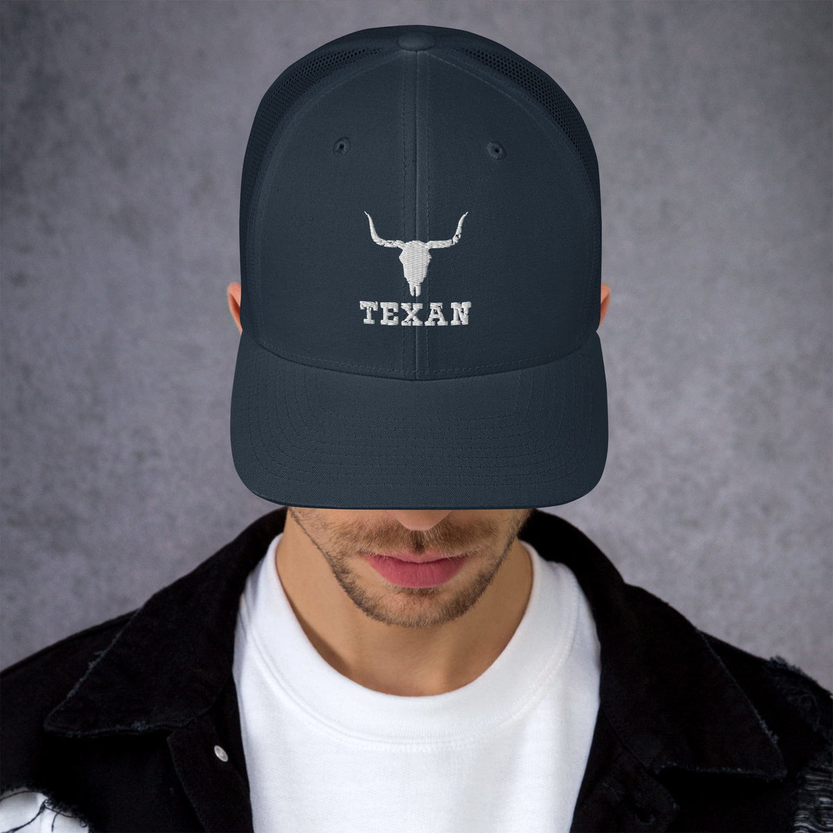 Dark navy trucker hat with white bull head and “TEXAN” lettering on the front panel.