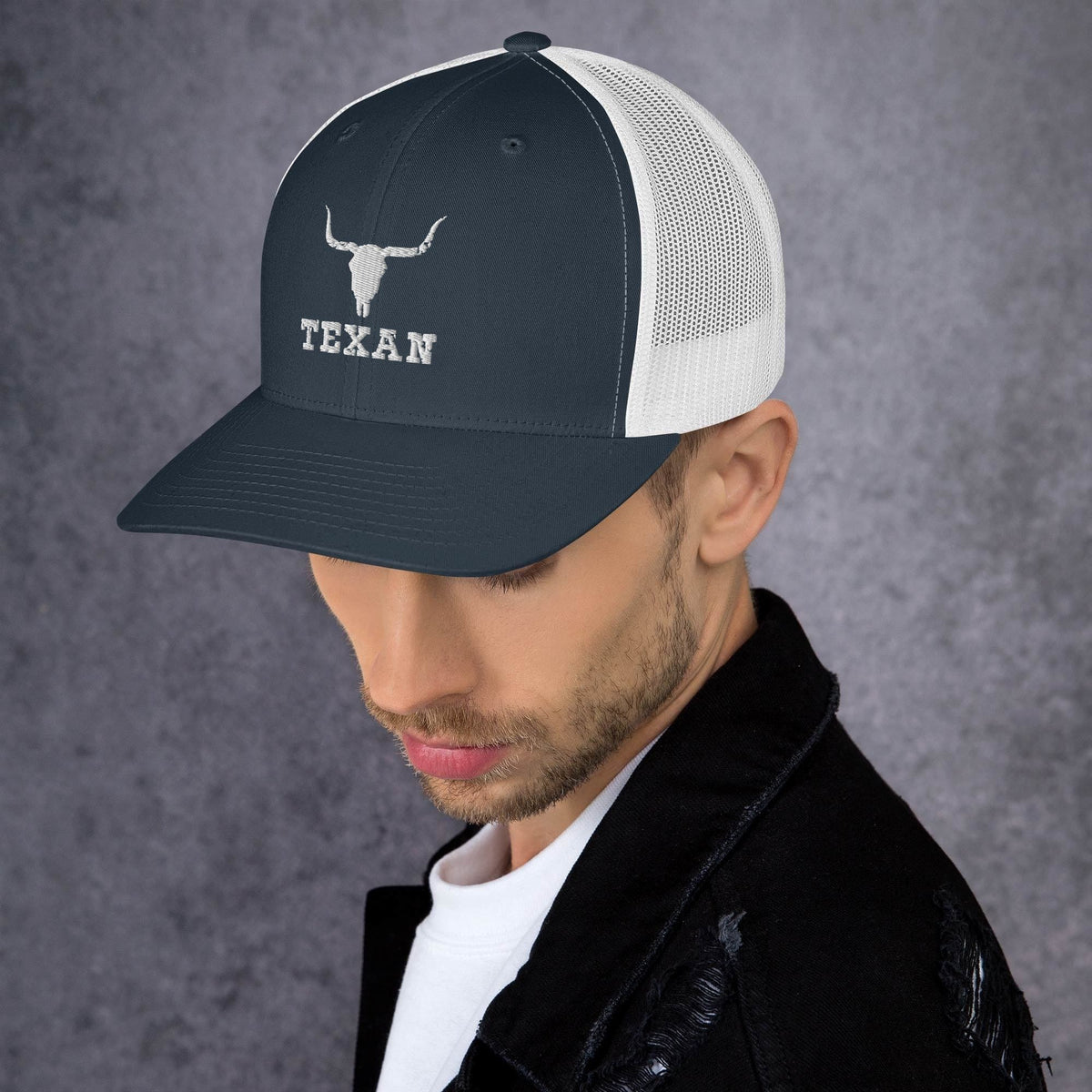 Navy and white mesh trucker hat with white bull head icon and “TEXAN” front text.