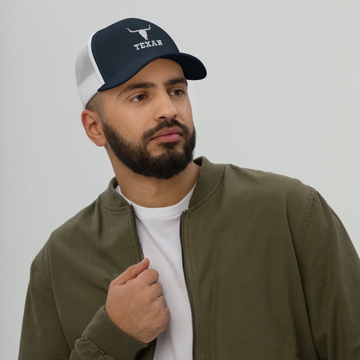 Navy trucker hat with white mesh panels and white bull and TEXAN logo on front