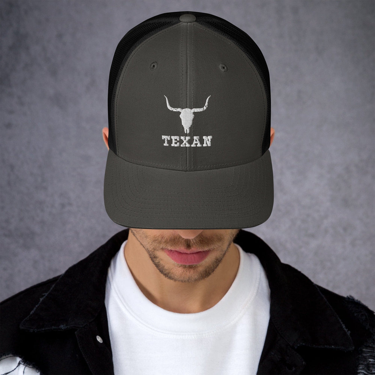 Black trucker hat with light gray bull and "TEXAN" embroidery