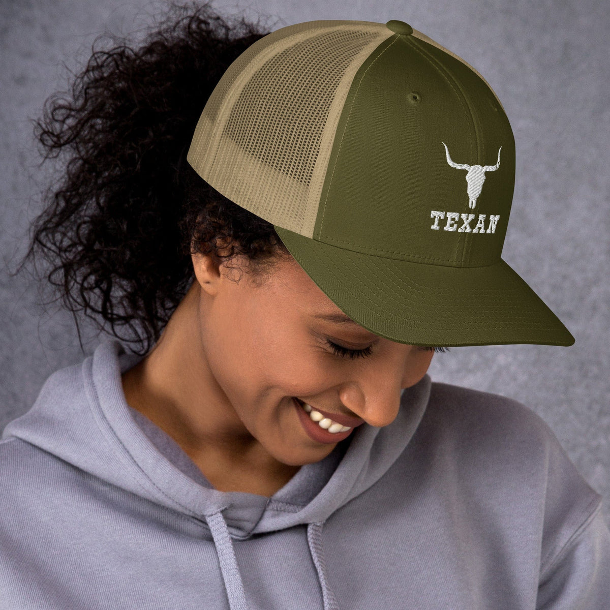 Two-tone trucker hat with green front and tan mesh panels, longhorn and “TEXAN” badge