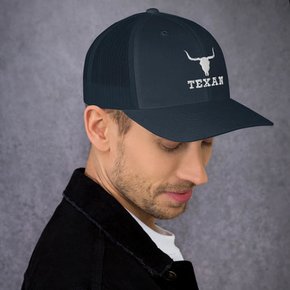 Dark trucker hat with a white bull head icon and “TEXAN” text on the front.