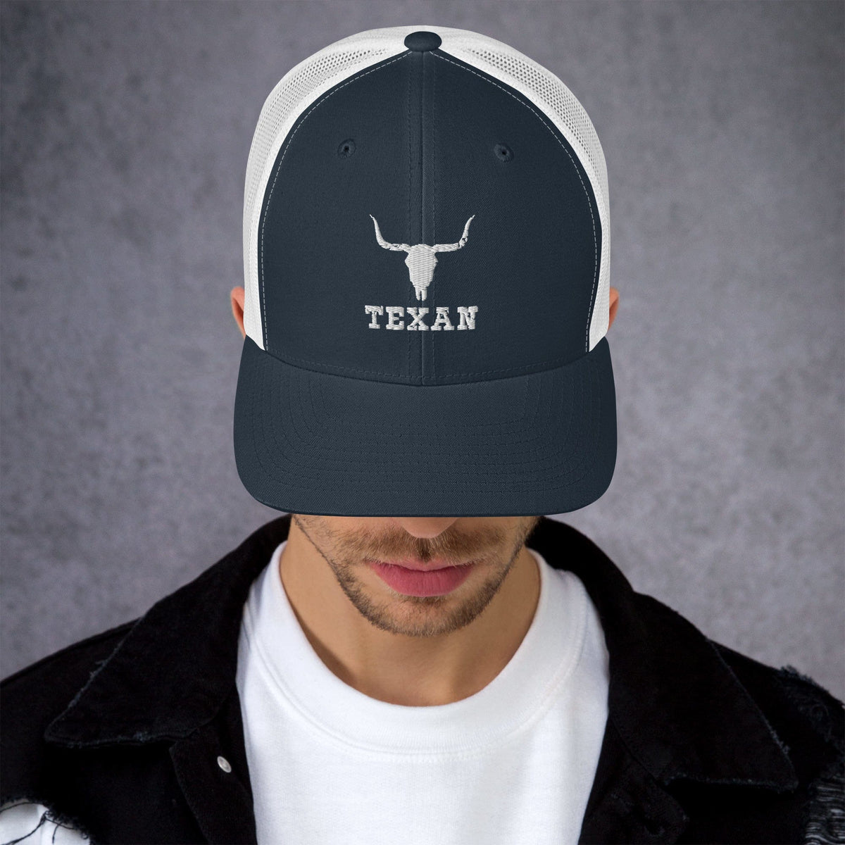Navy trucker hat with white bull and "TEXAN" embroidery