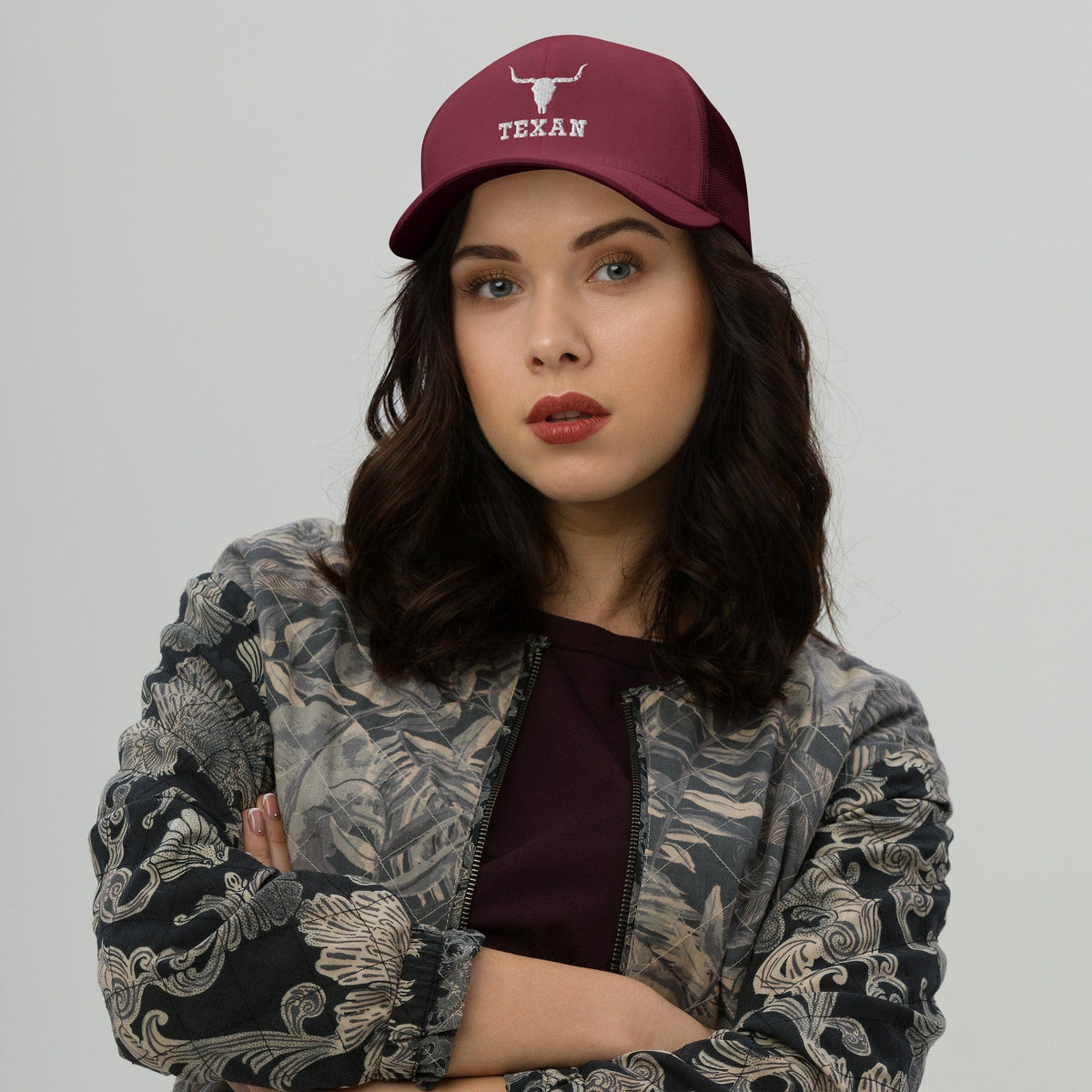Red trucker hat with solid crown and bull outline plus TEXAN text logo on front
