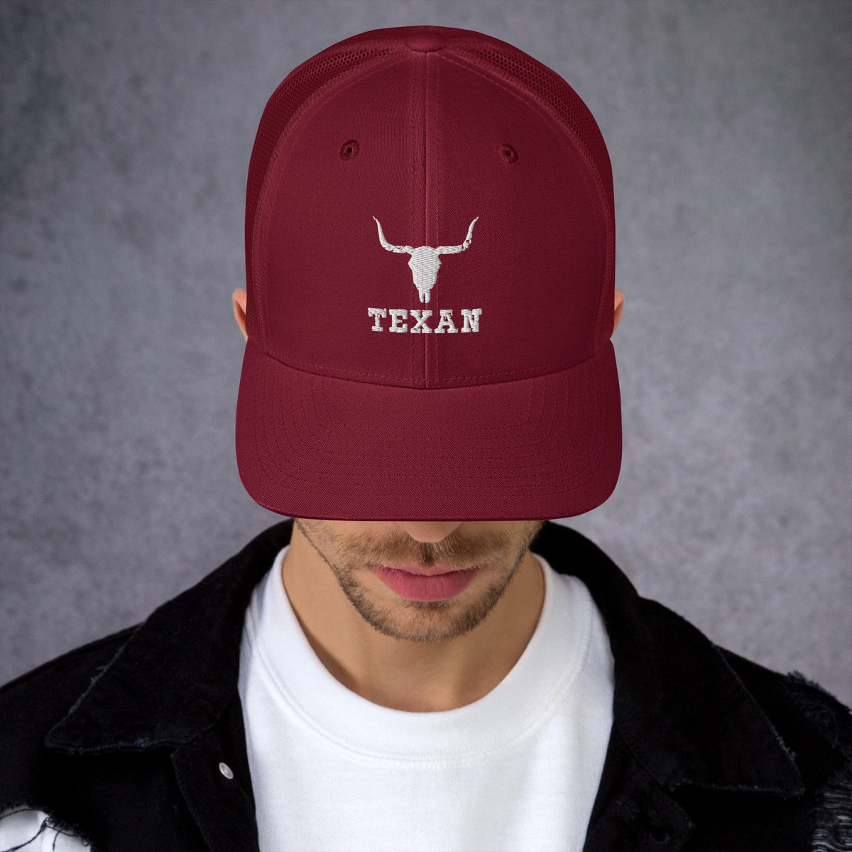 Burgundy trucker hat with white bull and "TEXAN" embroidery