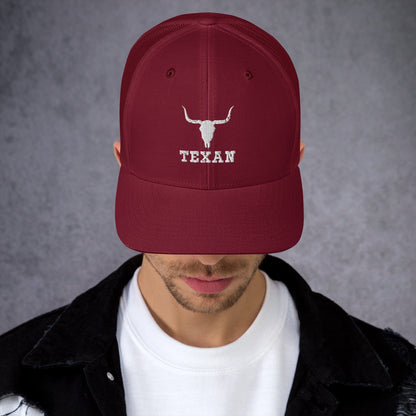 Burgundy trucker hat with white bull and "TEXAN" embroidery
