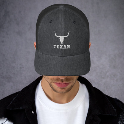 Dark gray trucker hat with mesh back and white bull and “TEXAN” patch on front
