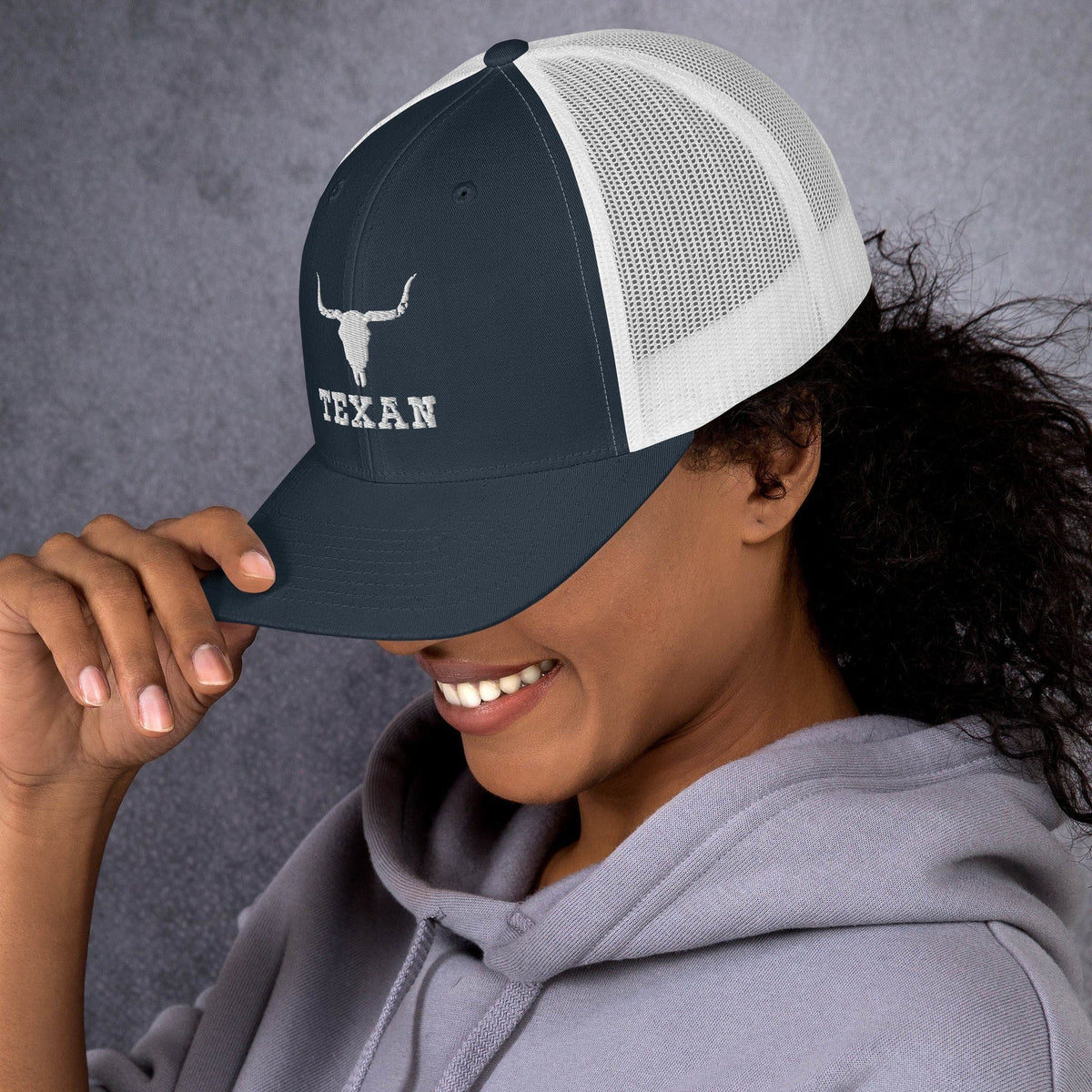 Dark navy trucker hat with white mesh front panels and bull and TEXAN logo
