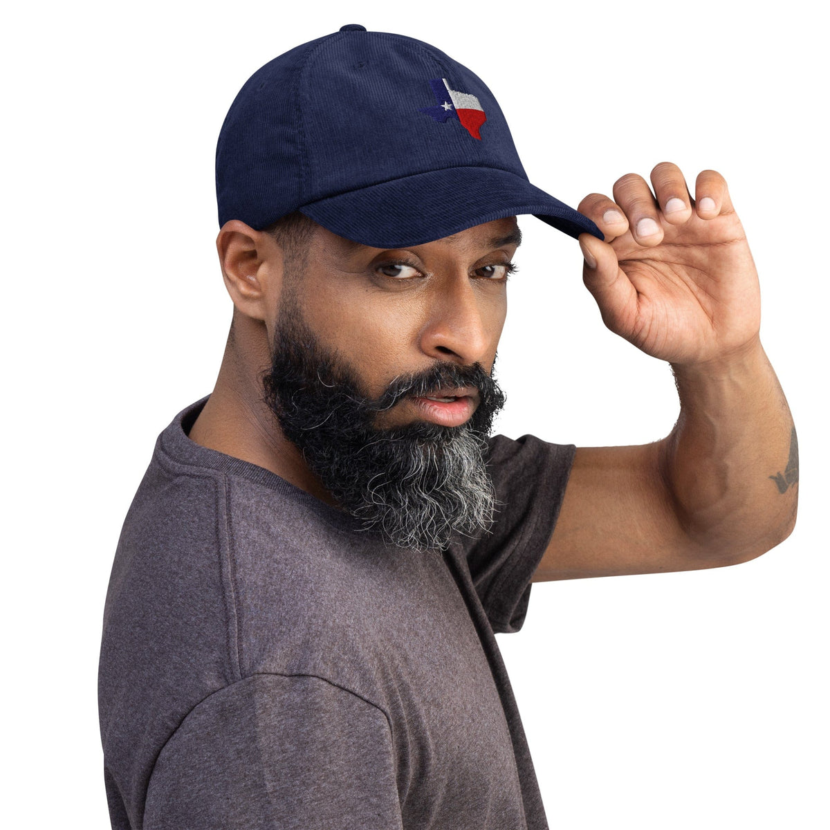 Navy corduroy baseball cap with embroidered Texas map and star, worn by model