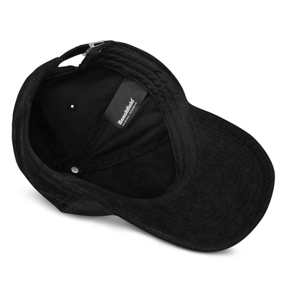 Black corduroy baseball cap showing inner label and adjustable strap.