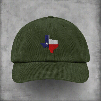 Green corduroy baseball cap with embroidered Texas map patch on front.