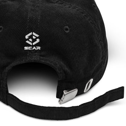 Black corduroy baseball cap with SCAR logo and metal buckle strap detail.