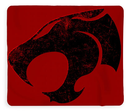 Red fleece blanket with distressed black Thundercats cat-face graphic