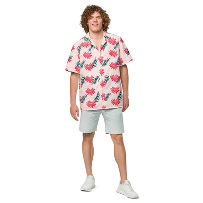 Short-sleeve tropical shirt in light pink with red blossoms and green foliage pattern.