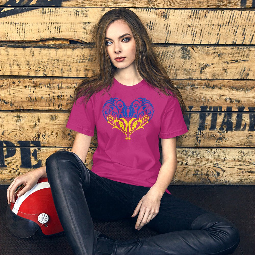 Magenta crew-neck T-shirt with blue-yellow heart emblem graphic on chest