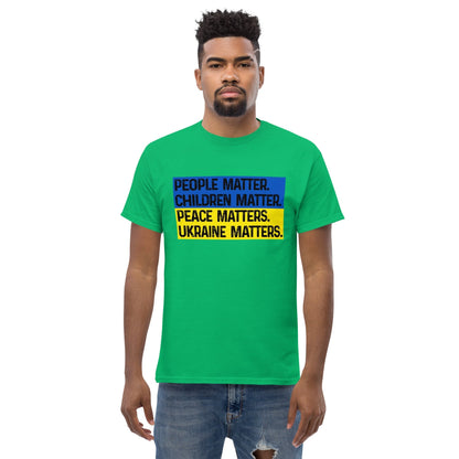 Green T-shirt with front square text graphic: People Matter, Children Matter, Peace, Ukraine Matters.