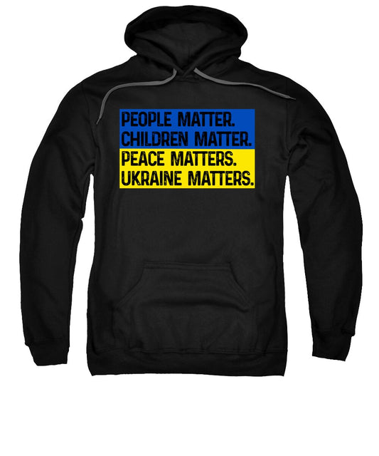 Black hoodie sweatshirt with front multicolor text graphic, People Matter Children Matter.