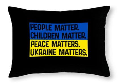 Black throw pillow with bold blue and yellow slogan text panel