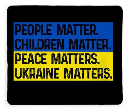 Black blanket with blue and yellow slogan print: PEOPLE MATTER, UKRAINE MATTERS