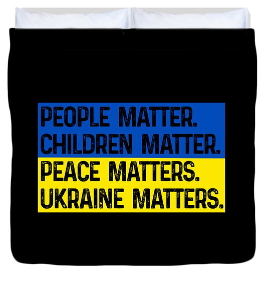 Black duvet cover with bold blue and yellow text: PEOPLE MATTER. CHILDREN MATTER.