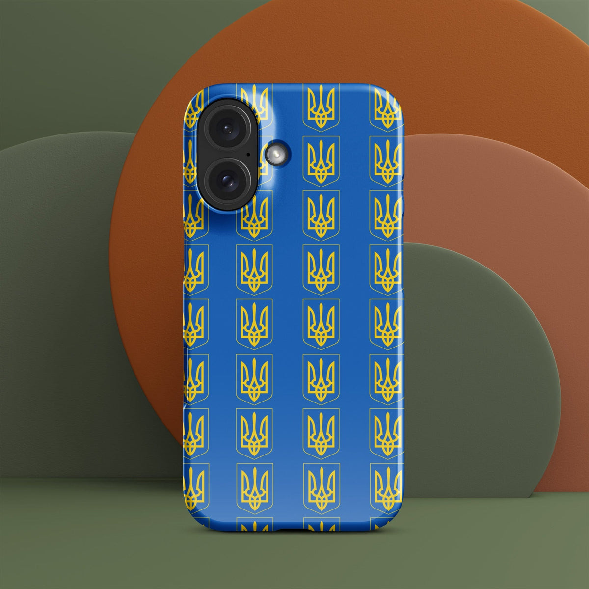 Blue iPhone case with repeating yellow Tryzub trident and shield pattern; left camera cluster.