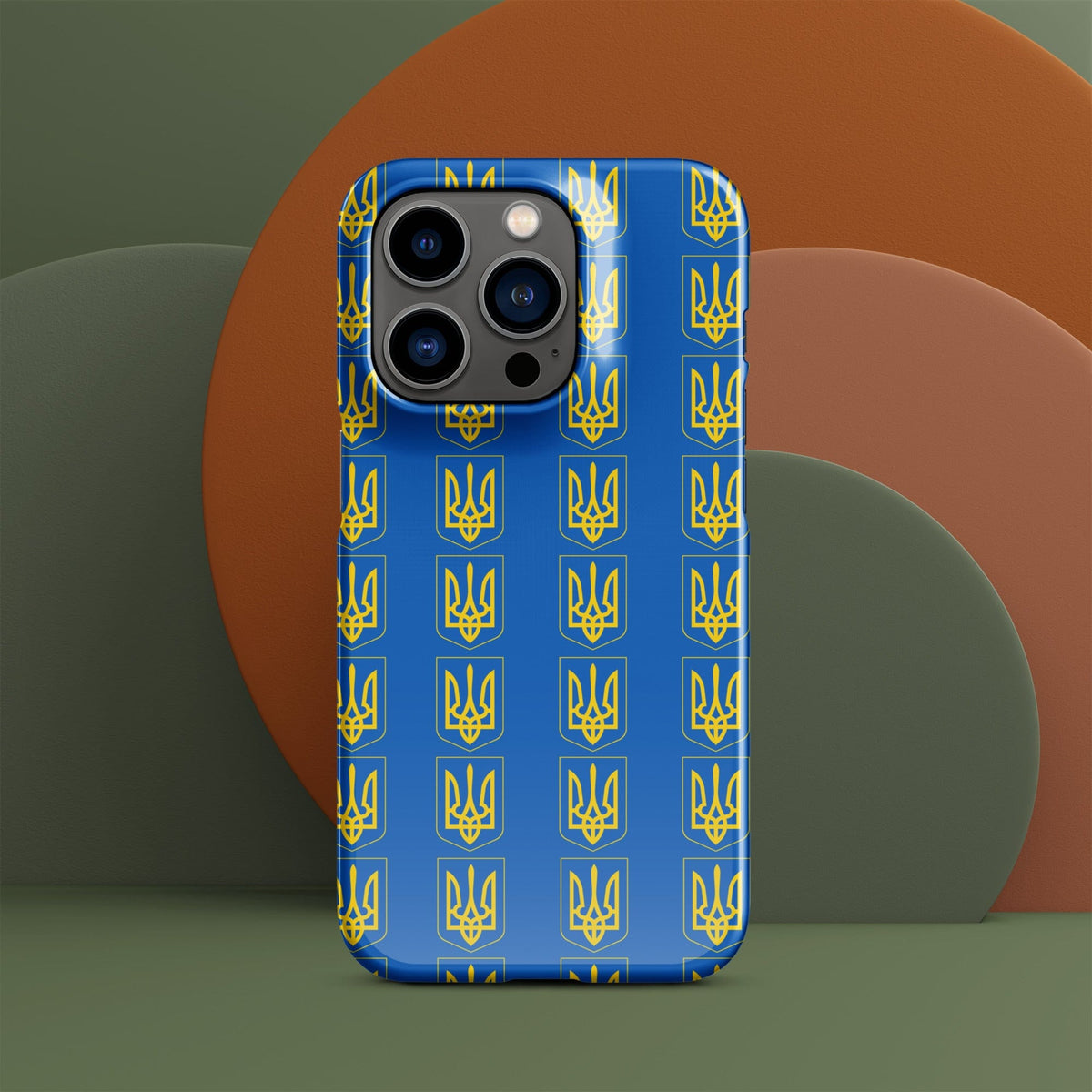 Blue iPhone case with repeating yellow Tryzub trident-and-shield pattern; three camera cutouts.