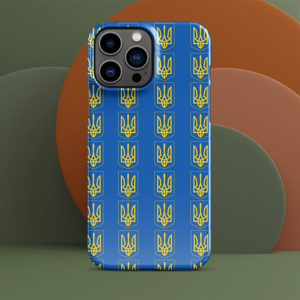 Blue iPhone case with repeating yellow Tryzub trident and shield pattern; camera cutouts.