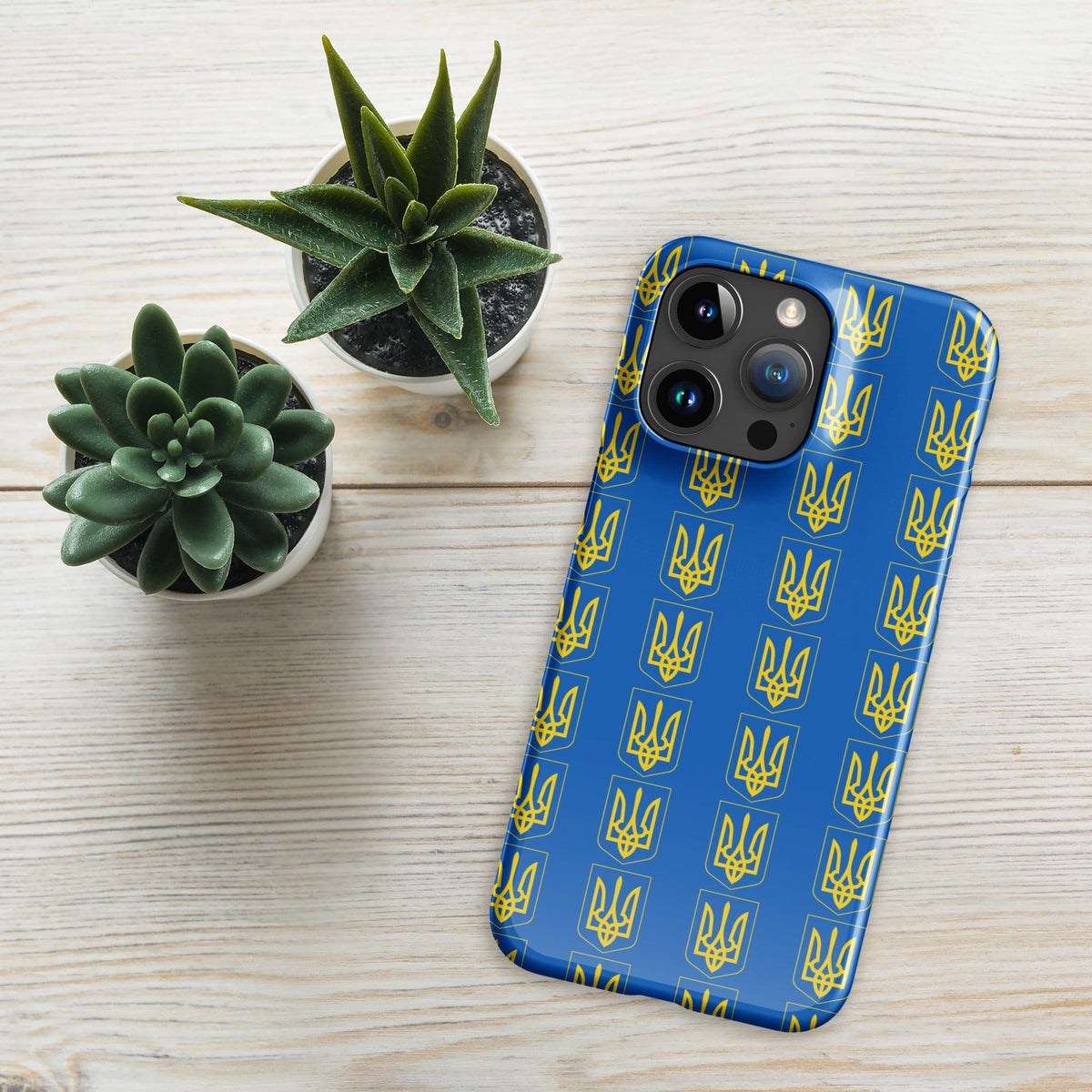 iPhone phone case with blue Tryzub trident pattern, angled view