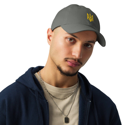 Grey Under Armour® cap with yellow Ukrainian trident emblem, worn front angle