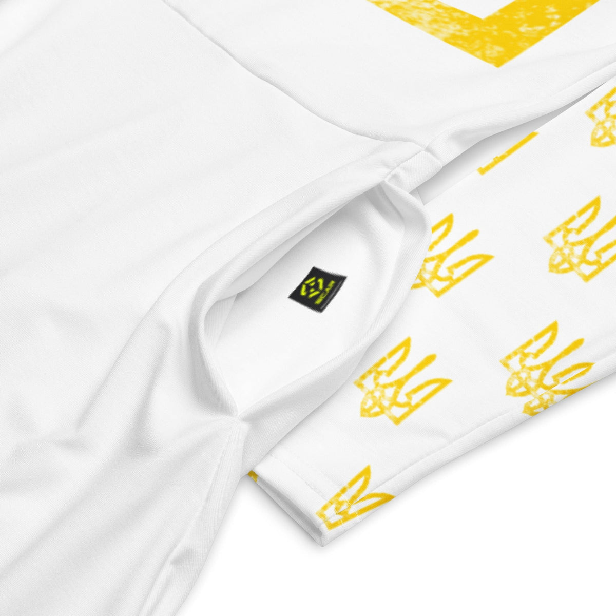 White long sleeve midi dress with yellow trident all-over print, close-up of sleeve seam