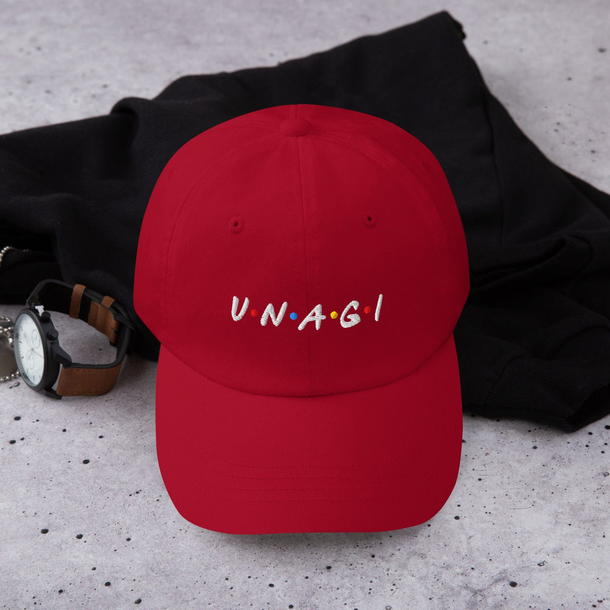 Red embroidered baseball cap with UNAGI logo stitching on front