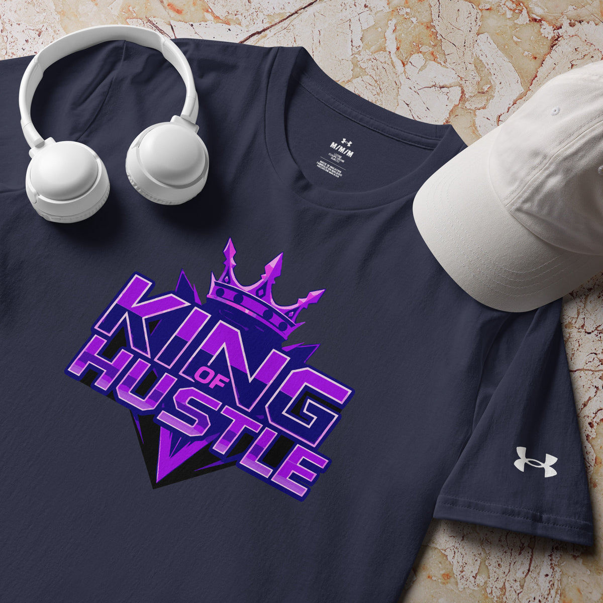 Navy athletic t-shirt with crew neck and purple "KING OF HUSTLE" graphic; Under Armour logo.