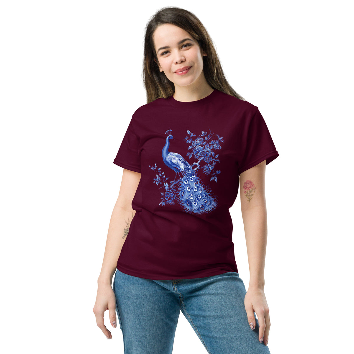 Maroon t-shirt with blue peacock and floral artwork on the chest, worn