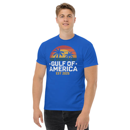 Royal blue crew-neck T-shirt with sunset palm tree graphic and “GULF OF AMERICA EST 2025” print