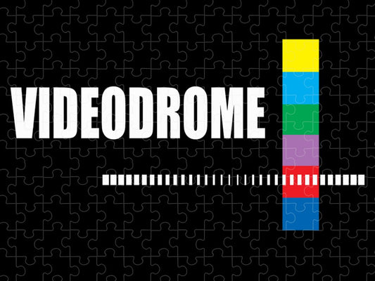 Jigsaw puzzle with “VIDEODROME” title, horizontal barcode stripe, and vertical color blocks