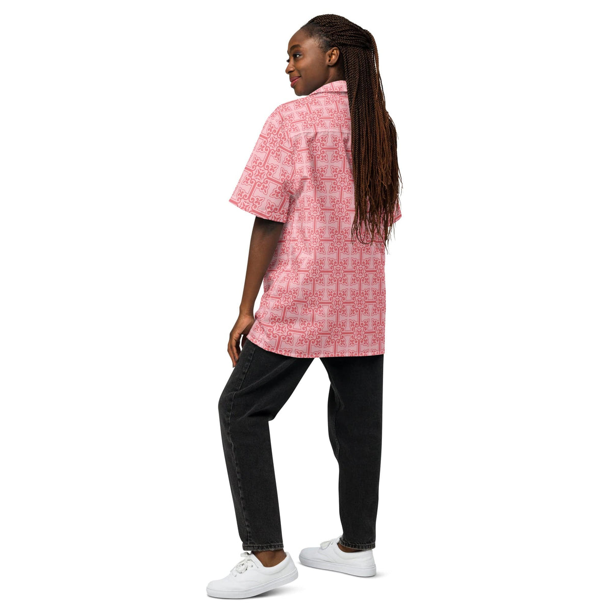 Pink patterned button-up shirt worn with black pants; side view, short sleeves.