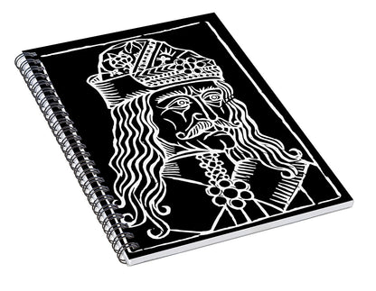 Spiral notebook with black cover and white woodcut-style portrait illustration, angled